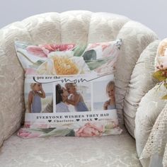 a white chair with a pillow on top of it next to a bouquet of flowers