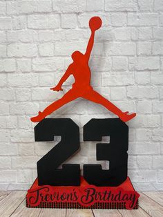 a red and black air jordan birthday cake topper with the number twenty five on it