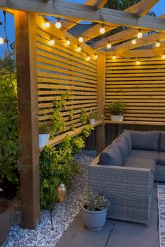 an outdoor living area with patio furniture and lights on the pergolated roof top