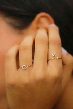 a close up of a person wearing two rings