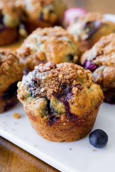 several blueberry muffins on a white plate