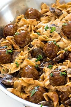 pasta with meatballs and mushrooms in a pan