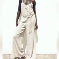 Brand New With Tag Size M Zara Sold Out Style!!! Cream Wide Leg Flowy Jumpsuit With Macrame Belt Cute Comfy And Stylish Chic Beige Jumpsuits And Rompers For Beach, Chic Beige Jumpsuit For The Beach, Beige Jumpsuits And Rompers For Beach Season, Beige Beach Jumpsuits And Rompers For Beach Season, Chic Cream Jumpsuits And Rompers For Vacation, Cream Jumpsuits And Rompers For Summer Beach, Summer Cream Jumpsuits And Rompers For Beach, Elegant Beige Jumpsuits And Rompers For Loungewear, Zara Jumpsuits And Rompers For Beach