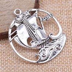 This adorable silver tone  charm is made from zinc alloy metal and is lead and nickel free. It's perfect for crafting necklaces, bracelets, earrings, bookmarks, key chains and more!    ♥ Antique Silver Tone  Pirate Ship Sailboat Charm   ♥ Material: Zinc Alloy Metal   ♥ Size: 43 x 39mm   ♥ Includes: 1 piece    We ship from North Carolina via USPS with tracking included. Tracking is included with all orders.   Get free shipping on orders over $35!  Don't forget to favorite us too, we add items daily.   Thank you... craft on. Silver Metal Charms For Jewelry Making, Nickel Free Round Metal Charms, Nickel-free Round Metal Charms, Nickel-free Metal Round Pendant Charms, Nickel Free Round Metal Pendant Charms, Nickel-free Round Metal Pendant Charm, Silver Round Metal Charms, Silver Metal Round Pendant Charm, Silver Round Pendant Charms