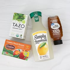 an assortment of juices and condiments on a white surface