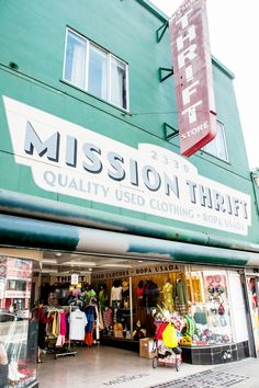 the front of a clothing store with clothes on display