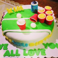 a birthday cake decorated with plastic cups and ping pong balls