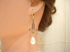 "Offering a pair of vintage inspired Art Nouveau / Art Deco style ivory pearl drop Downton Abbey statement earrings. These look like they were transported from the days of the Speakeasy and will be as perfect with a pair of jeans and a tee as a Bridal gown. Earrings hang down just under 2 1/2 inches (6.4 cm) from the TOP of the ear wire. I love the design of these treasures! High quality, lustrous teardrop shaped ivory glass pearls hang from elegant antique gold colored SO 1910s to 1920s designe Gown Earrings, 1920s Earrings, Bridal Dangle Earrings, Vintage Rhinestone Jewelry, Vintage Inspired Art, Art Deco 1920s, Art Nouveau Art, Nouveau Art, Pearl Bridal