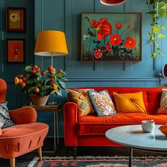 a living room with blue walls and orange furniture