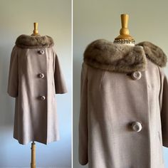 This elegant vintage coat features an understated finely woven wool; a matching luscious, face-framing collar that can be hooked close to fully wrap the neck; darling oversized top-stitched buttons; a swing shape; slightly bell sleeves; and an apricot satin lining. Two small repairs near wrist of sleeve (see photo). Pictured with room to spare on a US size 6/8 dress form.  Era: 1950s  Label: a Golet Original | blue and white ILGWU tag | Cohen's Sharon | RAS monogram | Pearl de Faille loomed for Elegant Fitted Taupe Outerwear, Brown Winter Wedding Outerwear, Winter Wedding Brown Outerwear, Elegant Vintage Fashion Outerwear For Fall, Elegant Fall Outerwear For Vintage Fashion, Vintage Winter Wedding Outerwear, Elegant Winter Outerwear For Vintage Fashion, Elegant Vintage Winter Outerwear, 1950s Fitted Winter Outerwear