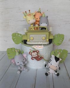 a cake with animals and giraffes on top