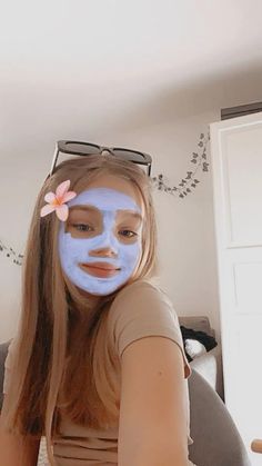 a girl with blue facial mask on her face