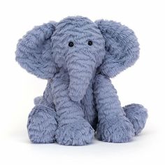 an elephant stuffed animal sitting on the ground