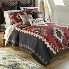 a bed covered in a red and black quilt