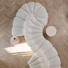 an overhead view of a living room with wood flooring and white furniture on top of it