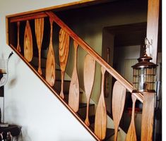 a wooden stair case with decorative handrails