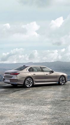 a silver car parked on top of a dirt field