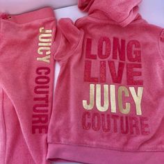 two pink hooded sweatshirts with gold lettering on the front and back, one is long live juicy couture