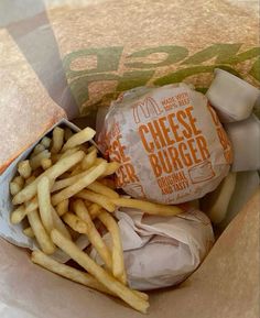 french fries and cheeseburger wrapped in brown paper