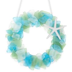 a starfish hangs on a wreath made out of sea glass