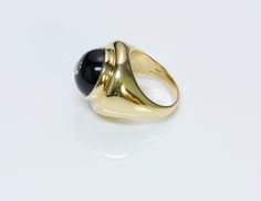 Tiffany & Co. Paloma Picasso Onyx & Diamond Gold Ring. Vintage Tiffany 18K yellow gold ring designed by Paloma Picasso. Solitaire ring with round black cabochon onyx and round brilliant cut diamond. Approximate Width: 0.9" Weight: 28.4 Grams Size: 10. Gold Ring Vintage, Diamond Gold Ring, Vintage Tiffany, Paloma Picasso, Gold Ring Designs, 18k Yellow Gold Ring, Diamond Gold, Onyx Ring, Yellow Gold Ring