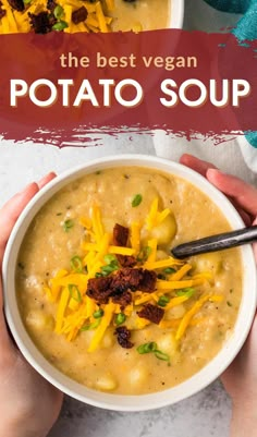 two hands holding a bowl of vegan potato soup