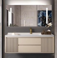 a bathroom vanity with two mirrors above it and a vase on the counter next to it