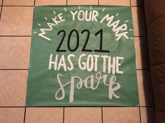 a sign on the floor that says, make your mark 2012 has got the spark