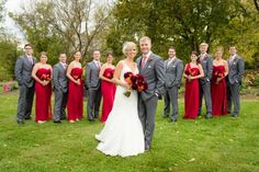 a bride and groom posing with their bridal party in the background at this wedding