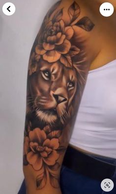 a woman's arm with a lion and flowers on it