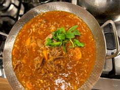 a bowl of stew is sitting on the stove