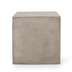 a concrete block sitting on top of a white floor