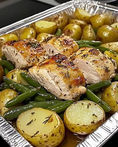 a pan filled with chicken, potatoes and green beans