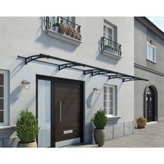 an image of a house with potted plants outside