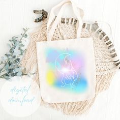 a tote bag sitting on top of a table next to some flowers and other items