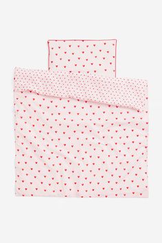 two sheets with hearts printed on them, one is pink and the other is red