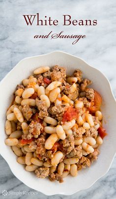 a white bowl filled with beans and meat