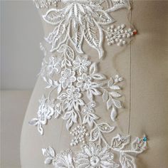 the back of a dress with white flowers on it