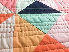 a close up view of a colorful quilt