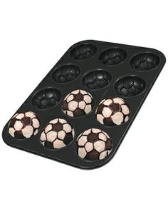 six soccer balls in a muffin pan