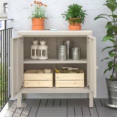 an outdoor shelf with pots and plants on it