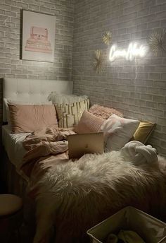 a white brick wall in a bedroom next to a bed with pillows and blankets on it