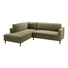 a green sectional couch sitting on top of a white floor