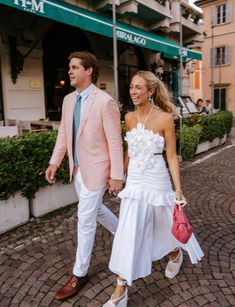 a man and woman are walking down the street