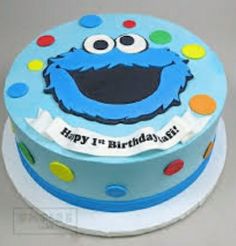 a blue birthday cake with an elmo face on it