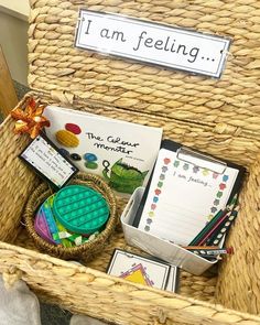 a wicker basket filled with books and writing materials