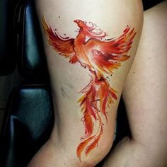 a woman's leg with a tattoo on it that has a bird painted on it