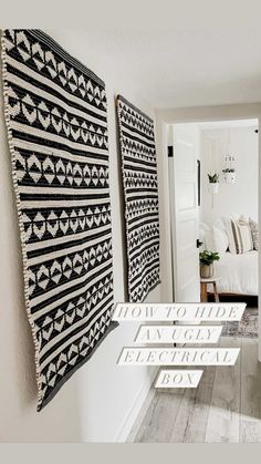 two black and white wall hangings in a living room