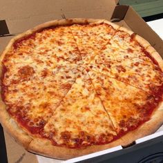 a pizza sitting in a box on top of a table