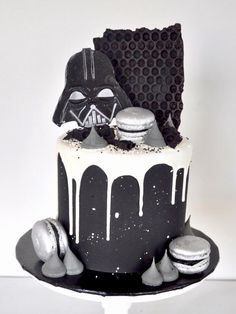 a star wars themed cake with white frosting and black icing on the top